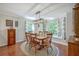Bright dining room with wood floors, traditional table, and bay window with cushioned seating at 121 Woodland Dr, Summerville, SC 29485
