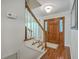 Welcoming foyer features a hardwood floor, staircase, and a charming wood front door at 121 Woodland Dr, Summerville, SC 29485