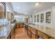 Gourmet kitchen with granite countertops, wood cabinets, island with cooktop, and stainless steel appliances at 121 Woodland Dr, Summerville, SC 29485