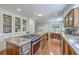 Bright and open kitchen featuring an island cooktop, wooden cabinetry, and access to a cozy breakfast nook at 121 Woodland Dr, Summerville, SC 29485