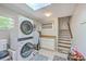 Laundry room with modern washer/dryer, skylight, storage cabinets, and access to stairs at 121 Woodland Dr, Summerville, SC 29485