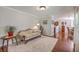 Comfortable living room featuring hardwood floors, a sofa, and an open dining area at 121 Woodland Dr, Summerville, SC 29485