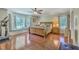 Bright and airy main bedroom with wood floors, large windows, window seat, and comfortable furnishings at 121 Woodland Dr, Summerville, SC 29485