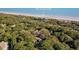 Stunning aerial view of houses nestled amidst lush trees near the beach, showcasing a serene coastal community at 1355 Dunlin Ct # Share D, Kiawah Island, SC 29455