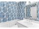 Stylish bathroom with palm leaf wallpaper, a white vanity with marble top, and modern fixtures at 1355 Dunlin Ct # Share D, Kiawah Island, SC 29455