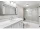 Bright bathroom features a large mirror, modern vanity with white countertop, and glass-enclosed shower-tub combo at 1355 Dunlin Ct # Share D, Kiawah Island, SC 29455