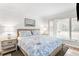 Inviting bedroom with shiplap walls, decorative lamps, a sailboat painting, and a cozy bed with patterned bedding at 1355 Dunlin Ct # Share D, Kiawah Island, SC 29455