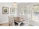 Dining room features a chandelier, shiplap wall, plantation shutters, and a rustic wood table at 1355 Dunlin Ct # Share D, Kiawah Island, SC 29455