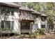 View of a charming two-story home featuring a balcony and surrounded by lush greenery, adding to its appeal at 1355 Dunlin Ct # Share D, Kiawah Island, SC 29455