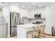 Modern kitchen with white cabinets, stainless appliances, island with breakfast bar, and light countertops at 1355 Dunlin Ct # Share D, Kiawah Island, SC 29455