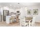 Modern kitchen features white cabinets, stainless steel appliances, and a breakfast bar with wooden stools at 1355 Dunlin Ct # Share D, Kiawah Island, SC 29455
