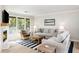 Cozy living room with fireplace, comfortable seating, striped rug and large windows providing outdoor views at 1355 Dunlin Ct # Share D, Kiawah Island, SC 29455