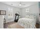 Bedroom boasts natural light, a ceiling fan, hardwood floors, and stylish decor with a patterned comforter at 137 Bratton Cir, Mount Pleasant, SC 29464