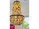 Close-up of a unique chandelier made of seashells, providing warm lighting in the dining area at 137 Bratton Cir, Mount Pleasant, SC 29464