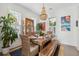 Elegant dining room with a large wooden table, wicker chairs, plants and a decorative chandelier at 137 Bratton Cir, Mount Pleasant, SC 29464