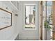 Clean entryway featuring a bench, white walls, decor, and a view of the home's exterior through a window at 137 Bratton Cir, Mount Pleasant, SC 29464