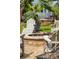 Cozy fire pit area with stone surround, seating, and landscaping, designed for outdoor relaxation at 137 Bratton Cir, Mount Pleasant, SC 29464