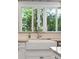 Farmhouse sink paired with modern faucet overlooking the outdoor greenery through the window at 137 Bratton Cir, Mount Pleasant, SC 29464