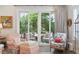 Cozy living room featuring pink patterned armchairs and bright light from glass patio doors at 137 Bratton Cir, Mount Pleasant, SC 29464