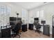 Spacious office with desks, multiple monitors, and natural light from shuttered windows and hardwood floors at 137 Bratton Cir, Mount Pleasant, SC 29464