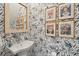 Stylish powder room features patterned wallpaper, a decorative mirror, and framed art prints at 137 Bratton Cir, Mount Pleasant, SC 29464