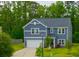 Charming two-story home with blue siding, white trim, well-kept lawn, and attached garage at 1387 Thin Pine Dr, Johns Island, SC 29455