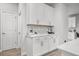 Kitchen area with white cabinetry, marble backsplash, and modern decor accents at 1387 Thin Pine Dr, Johns Island, SC 29455