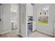 Bright kitchen area with mini fridge, white cabinets, and backyard view at 1387 Thin Pine Dr, Johns Island, SC 29455