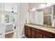 Bathroom with double sink vanity, granite counters, and view to bedroom with ceiling fan at 1446 Crane Creek Dr, Mount Pleasant, SC 29466