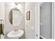 Powder room featuring round mirror, pedestal sink, and neutral wall color at 1446 Crane Creek Dr, Mount Pleasant, SC 29466