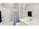 Bathroom with shower-tub combo with blue curtain, single sink, and decor at 1446 Crane Creek Dr, Mount Pleasant, SC 29466