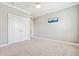 Minimalist bedroom featuring neutral carpet and walls, white trim, and a double-door closet at 1446 Crane Creek Dr, Mount Pleasant, SC 29466
