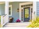 Cozy front porch with seating, decorative plants, and a view of the beautifully landscaped yard at 1446 Crane Creek Dr, Mount Pleasant, SC 29466