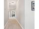 Neutral-toned hallway featuring a carpeted floor, white trim, and doors to multiple rooms at 1446 Crane Creek Dr, Mount Pleasant, SC 29466