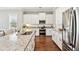 Bright kitchen features a large granite island, white cabinets, and stainless steel appliances at 1446 Crane Creek Dr, Mount Pleasant, SC 29466