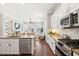 Open kitchen with stainless steel appliances, granite counters, and an open view to the living area at 1446 Crane Creek Dr, Mount Pleasant, SC 29466