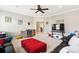 Bright, carpeted room with dark leather sofas, ceiling fan and a glimpse into the dining area at 1446 Crane Creek Dr, Mount Pleasant, SC 29466