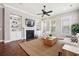 Living room features a ceiling fan, built-in bookshelves, and fireplace with a mounted TV at 1446 Crane Creek Dr, Mount Pleasant, SC 29466