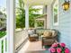 Relaxing front porch featuring comfortable seating, outdoor rug, and neighborhood views at 1446 Crane Creek Dr, Mount Pleasant, SC 29466