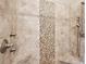 Shower featuring tile surround with decorative mosaic stripe and built-in corner shelves at 1446 Crane Creek Dr, Mount Pleasant, SC 29466