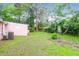 Spacious backyard featuring a pink exterior, lush grass, and shaded areas, perfect for outdoor enjoyment at 1514 Patterson Ave, Charleston, SC 29412