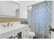 Well-lit bathroom with a marbled vanity and leaf-patterned shower curtain at 1514 Patterson Ave, Charleston, SC 29412
