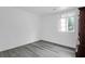 Bedroom featuring wood-look floors, white walls and a window, creating a bright and airy space at 1514 Patterson Ave, Charleston, SC 29412