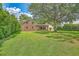 Spacious backyard with a large lawn, trees, and a view of the home's exterior at 17 Johnson Rd, Charleston, SC 29407