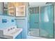 Blue bathroom with a sink, toilet, vanity, tub, and shower with sliding glass door at 17 Johnson Rd, Charleston, SC 29407