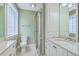 Well-lit bathroom featuring vanity, tile floors, glass enclosed shower and a glass block window at 17 Johnson Rd, Charleston, SC 29407