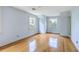 Spacious light blue bedroom features hardwood floors and two large windows at 17 Johnson Rd, Charleston, SC 29407