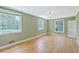Spacious bedroom featuring multiple windows, hardwood floors, and light green walls at 17 Johnson Rd, Charleston, SC 29407