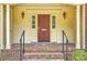 Covered front porch with brick steps and classic door with sidelights and ornate trim at 17 Johnson Rd, Charleston, SC 29407