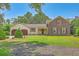 Charming brick home with a lush front lawn, two-car garage, and shuttered windows at 17 Johnson Rd, Charleston, SC 29407